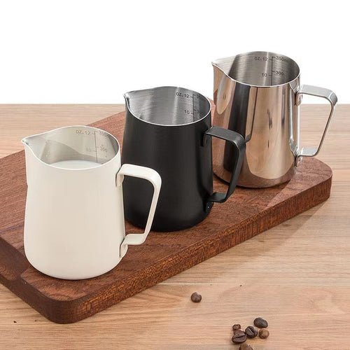Milk pitchers on a wooden board