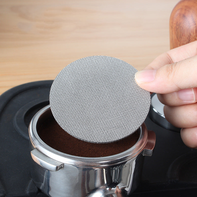 Puck screen placed on a tamped espresso puck