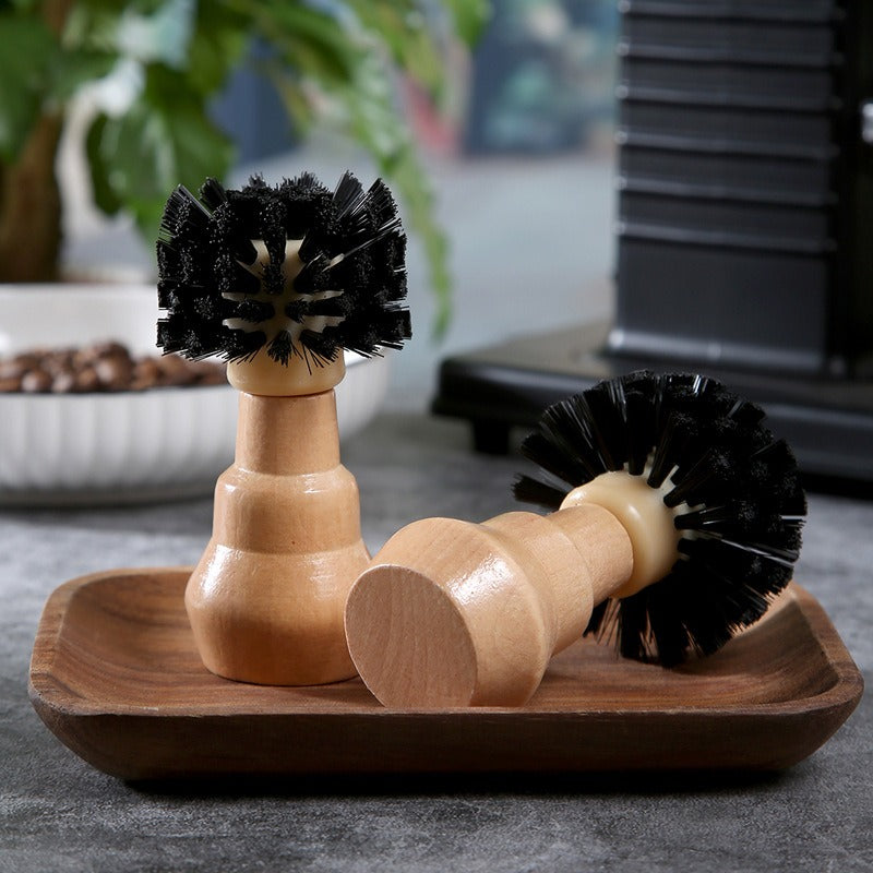 Cleaning brush in use on espresso machine
